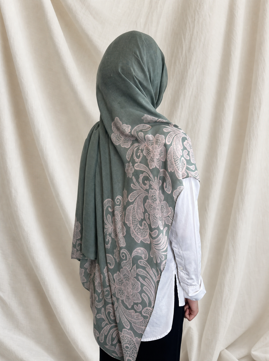 Jade Lace printed hijab by The Noorea Collection, back view, white drapery backdrop