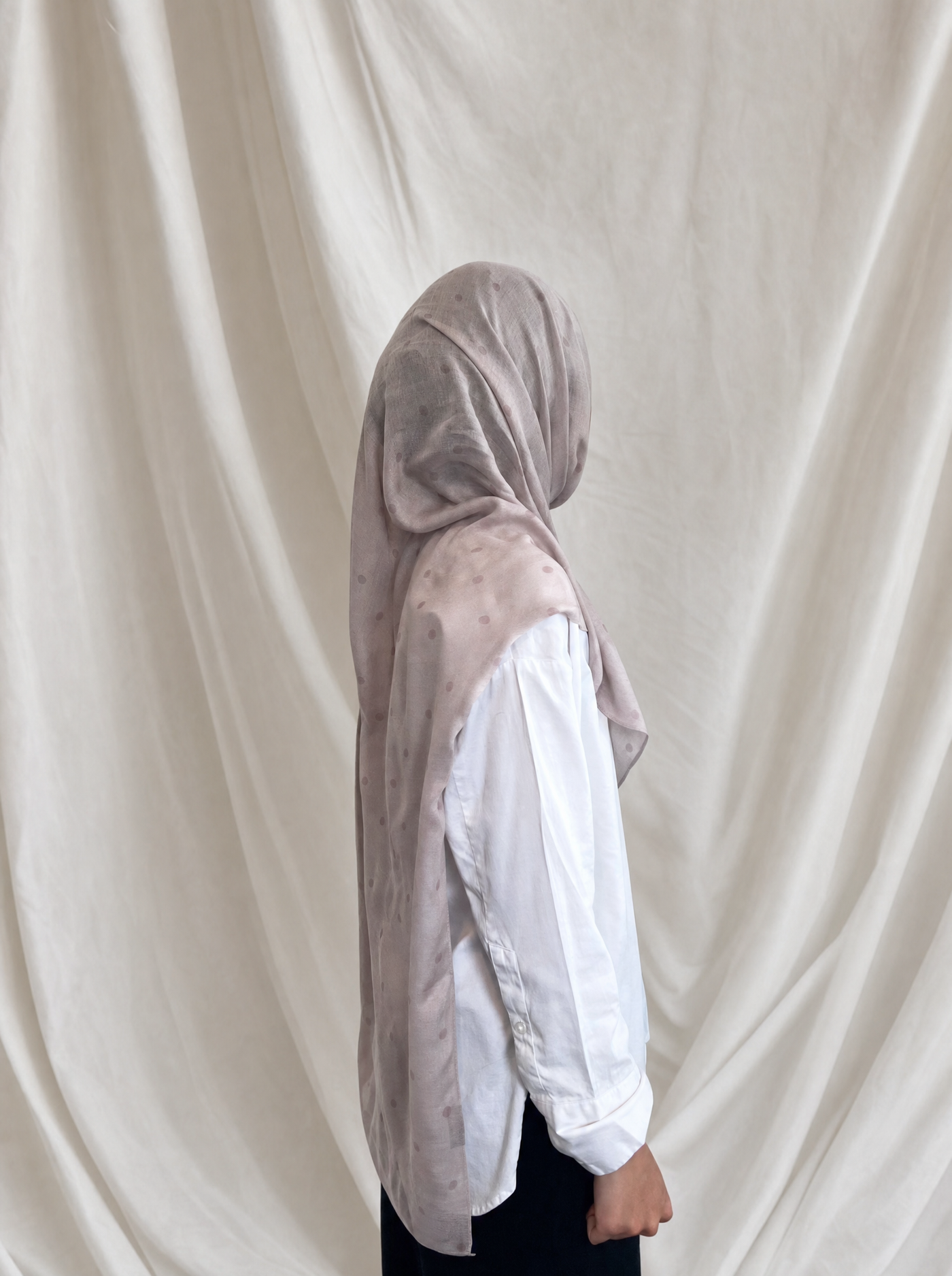 Pearl Polka Dot printed hijab by The Noorea Collection, side view, white drapery backdrop