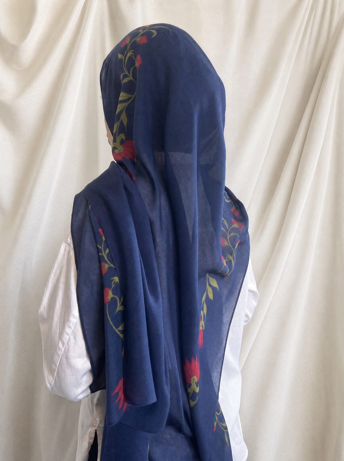 Sapphire Rose printed hijab by The Noorea Collection, back view, white drapery backdrop